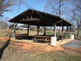 The Pavilion has a concrete floor and electrical wiring and lighting.  The area can accommodate between 50 to 75 people.  It also has a propane grill and picnic tables.